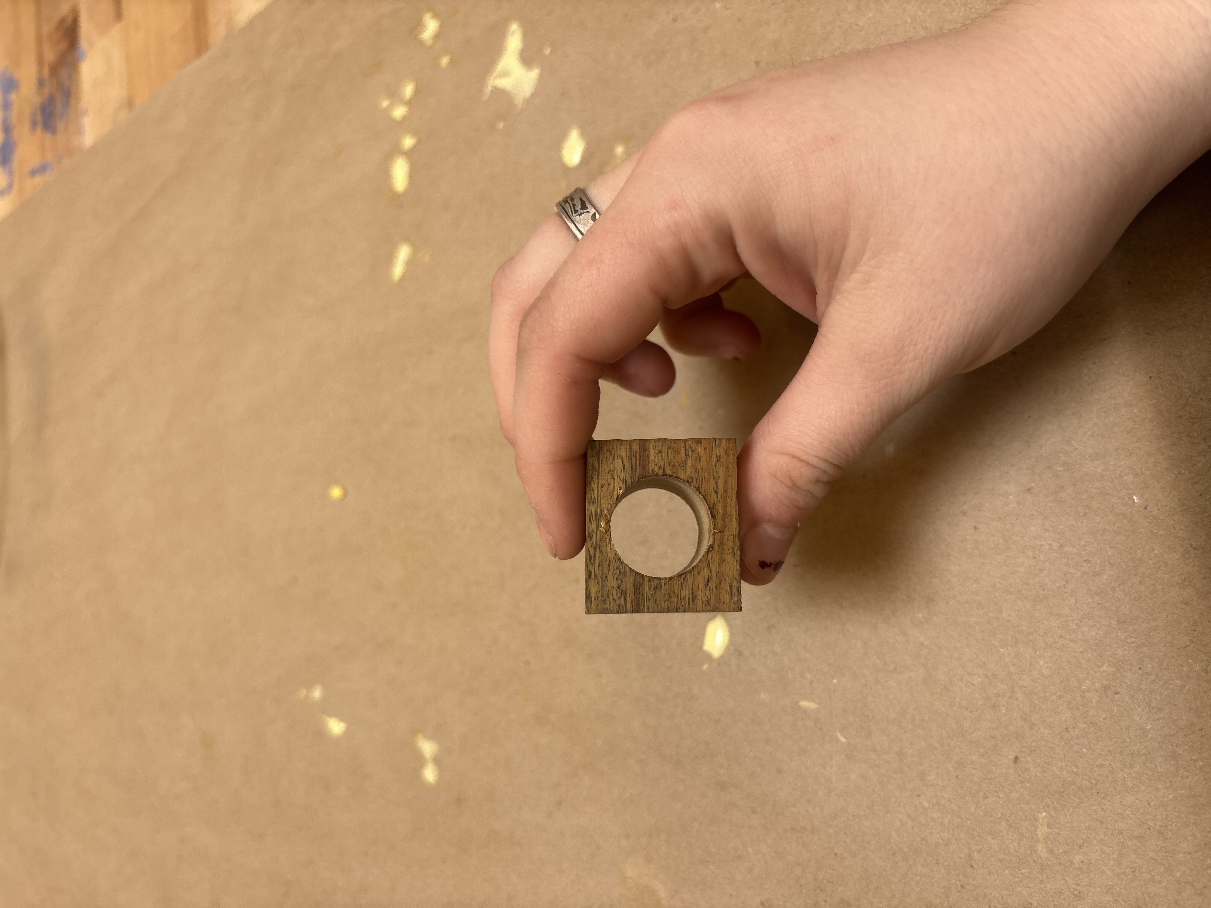 Used a drill press to drill a hole in a scarp of the Lignam Vitae wood from a previous project